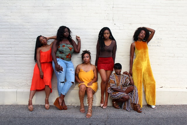 six-women-leaning-on-white-wall
